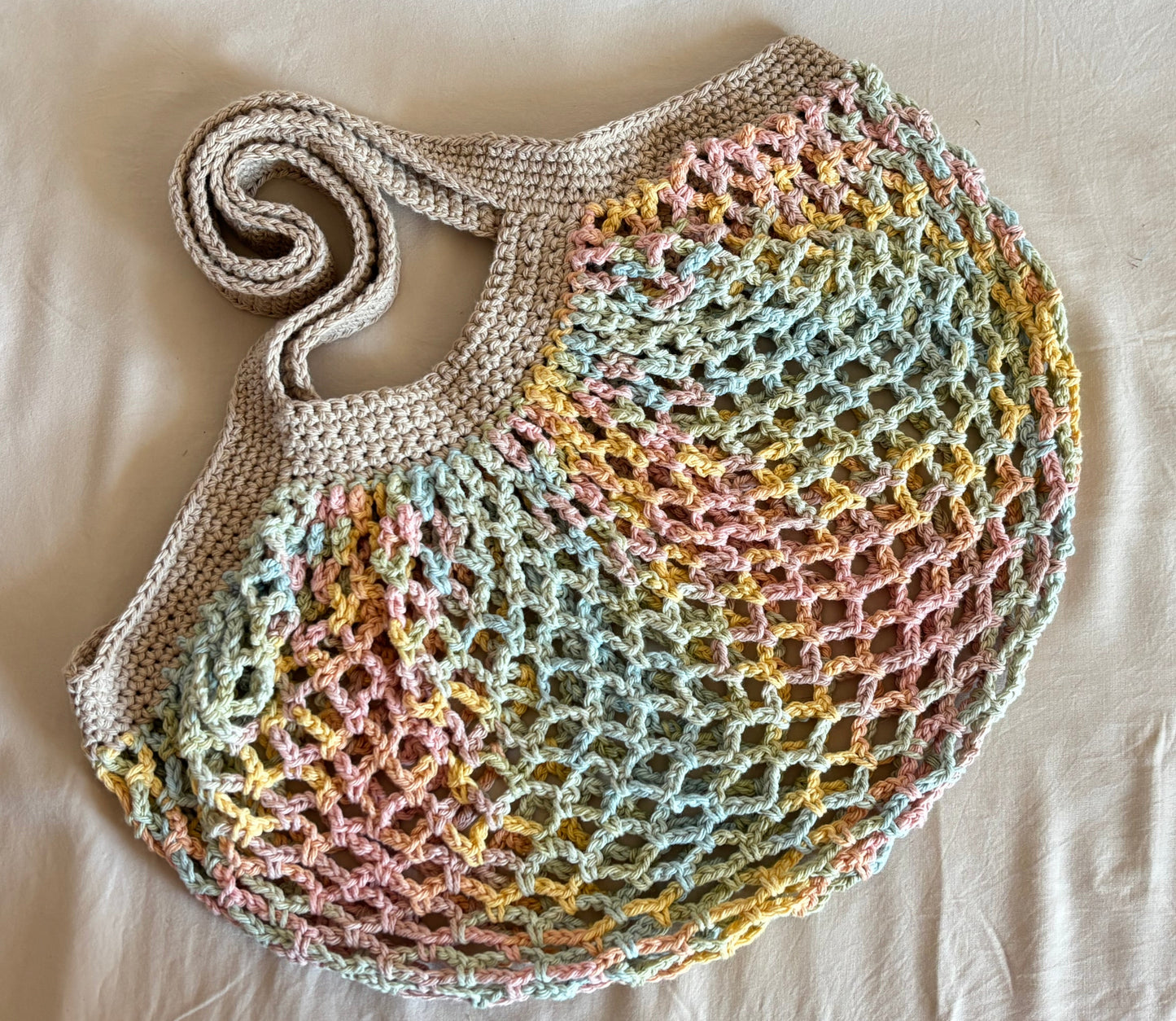 Colorful crochet market bag on a light background